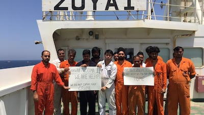 The crew of the Zoya stand on the deck of the supertanker having been stranded for more than a year off the coast of Sharjah. Zoya crew