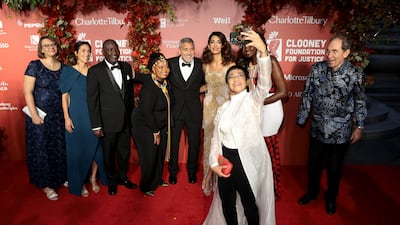 Ressa takes a selfie with, from left, Alina Stefanovic, Sarah-Christine Dallain, Oumda Haroun, Wanjiru Wahome, George Clooney, Amal Clooney, Dr Josephine Kulea and Justice Albie Sachs at the Clooney Foundation For Justice Inaugural Albie Awards in New York, in September 2022. Getty
