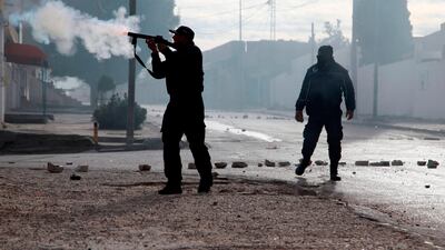 Policemen fire teargas towards protesters during a demonstration. AFP