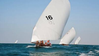 Skipper Mohammed Rashid Bin Shaheen leads the field in a 43 ft wooden racing dhow during a traditional dhow sailing race in Dubai.