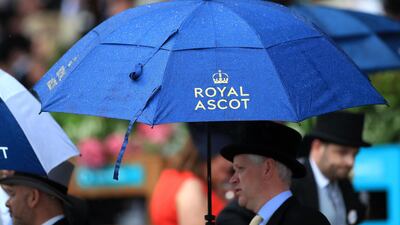 Racegoers hold umbrellas in the rain during Day 1 of Royal Ascot. Press Association