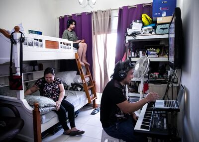 Anthony plays the keyboard for wife Analiza and son Raoul. Reem Mohammed / The National