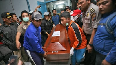 Relatives carry a coffin containing the body a victim of the eruption. Binsar Bakkara / AP Photo
