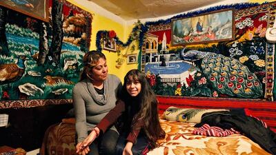 Niculina Fieraru, 39, with her daughter Flori Gabriela Dumitrache, 13, in their room in Gura Sutii village, Romania. Niculina Fieraru is currently unemployed and hopes that her daughter Flori Gabriela will become a seamstress. Flori Gabriela wants to become a pop singer and she hopes to go to high school but her family cannot afford to pay for it. A Romanian NGO has offered a scholarship to make it possible. Bogdan Cristel / Reuters