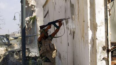 A member of the Libyan National Army fires his weapon in Benghazi's central Akhribish district on July 6, 2017. AFP / Abdullah Doma