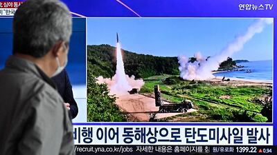 A man watches a news broadcast showing file footage of a North Korean missile test, at a railway station in Seoul on Friday. AFP