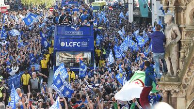 The Leicester City squad parade the Barclays Premier League trophy through the streets of the English city on May 16, amid exuberant fans. Michael Regan / Getty Images.
