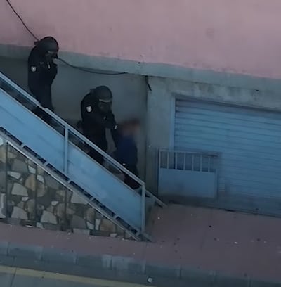 A suspect is led away by Spanish police officers. Photo: Europol
