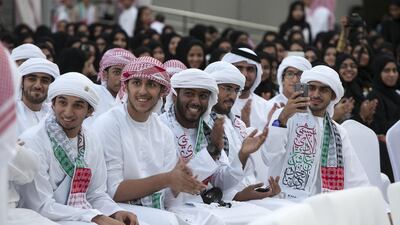 Students applaud as their countrymen perform the traditional Yolla dance with wooden sticks at Khalifa University yesterday. Silvia Razgova / The National