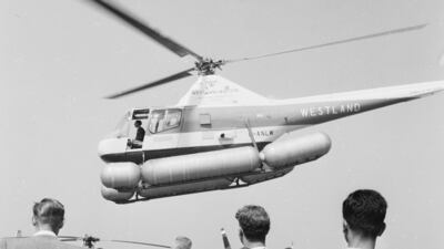 A Westland Widgeon helicopter hovers above the Farnborough Airshow crowd in 1959.