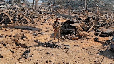 A Lebanese army soldier walks amidst the debris at Beirut port. AFP / JOSEPH EID