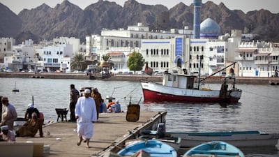 Backed by the white buildings that line the corniche of Mutrah district, fishermen and delivery staff work near the Mina Sultan Qaboos in downtown Muscat. Silvia Razgova / The National