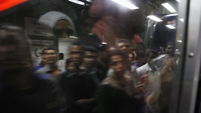 Egyptian men board a car at Al Shohadaa (Martyrs) metro station.