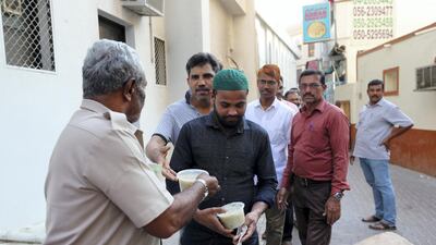 Worshippers wait in line for Iftar food.