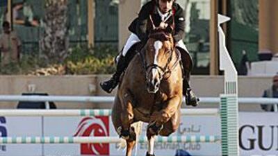 Sheikh Rashid Ahmed Al Maktoum rides Dubai's Pride during the class two competition in the Dubai Show Jumping Championship.