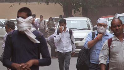 People cover their faces as a dust storm sweeps through New Delhi. Manish Swarup / AP Photo