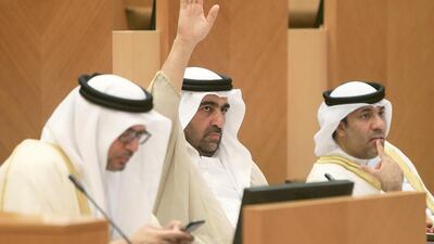 Dr Rashid bin Fahad, centre, Minister of Water and Environment with Dr. Anwar Mohammed Gargash, left, Minister of State for Foreign Affairs and Minister of State for Federal National Council Affairs at an FNC session in Abu Dhabi. Ravindranath K / The National