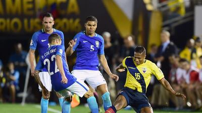 Ecuador’s Pedro Larrea, right, vies for the ball with Brazil’s Philippe Coutinho. Frederic J. Brown / AFP