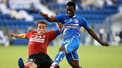 Ismael Bangoura, right, scores Al Nasr's second goal against Al Ahli, despite the attentions of Ahli captain Fabio Cannavaro.