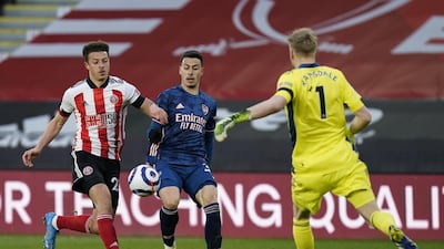 Arsenal's Gabriel Martinelli in action against Sheffield's Ethan Ampadu and goalkeeper Aaron Ramsdale. EPA