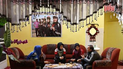 Frozan Rasooli, left, Zahra Alizada, second left, and Masooma Alizada have breakfast with their coach Abdul Sadiq Sadiqi (R). Mohammad Ismail / Reuters