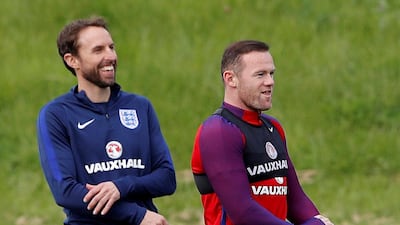 Wayne Rooney, right, received a phone call from England manager Gareth Southgate, left, on Tuesday telling him he was recalled for England's upcoming 2018 World Cup qualifiers. Rooney announced his international retirement on Wednesday. Carl Recine / Reuters
