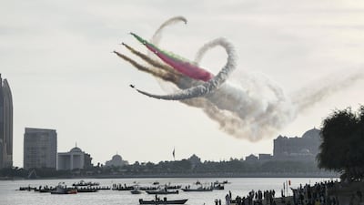 The Al Fursan aerobatic team light up the skyline of Abu Dhabi. Khushnum Bhandari / The National