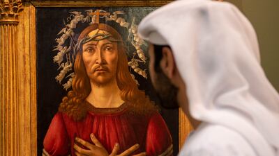 A visitor looks at Sandro Botticelli's 'The Man of Sorrows' at Sotheby's Dubai in DIFC. Ryan Lim for The National