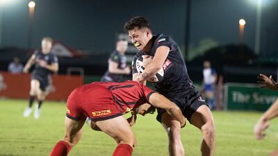 Dubai Exiles full-back Willem Jansen is tackled.