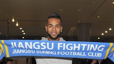 Brazilian striker Alex Teixeira poses for photos upon his arrival at the airport in Nanjing in eastern China's Jiangsu province. Chinese Super League clubs have splashed out millions in the winter transfer window on big names from Europe and South America such as Ramires, Alex Teixeira, Ezequiel Lavezzi, Jackson Martinez and Gervinho. (Color China Photo via AP)