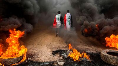 Burning tyres block a road in the southern Iraqi city of Basra on November 17, 2019. AFP