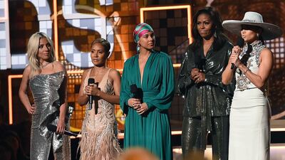 Michelle Obama made a surprise appearance on stage, skipping the red carpet, wearing a wide leg pant suit by New York-based Indian designers Sachin & Babi. Photo: AFP
