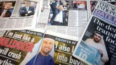 Newspapers displaying a story on Manchester City's takeover by the Abu Dhabi United Group for Development and Investment.