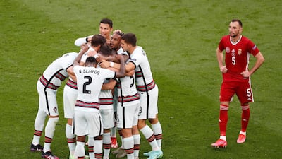 Raphael Guerreiro is mobbed by teammates after breaking the deadlock in Budapest. Getty