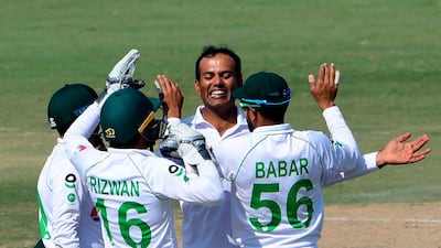 Pakistan's Nauman Ali celebrates with teammates after taking the wicket of South Africa's Anrich Nortje during the fourth day of the first Test at the National Stadium in Karachi on Friday. AFP