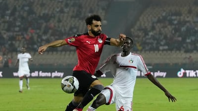 Egypt's Mohamed Salah, left, is challenged by Sudan's Mustapha Abdelgader Karshoum. AP Photo