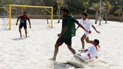 Humaid Jamal, left, and the UAE beach soccer team training at Mumzaar Park in Dubai. Pawan Singh / The National