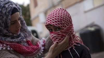 Yasmeen Hamdan with her young cousin, 8: ‘I will be proud if he dies and becomes a martyr.’ Heidi Levine for The National