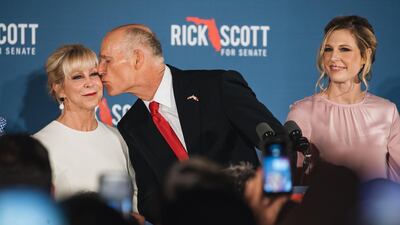 Senator-elect Rick Scott, governor of Florida, kisses wife Ann Scott while speaking to attendees during an election night rally in Naples, Florida. Bloomberg