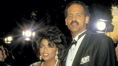 Oprah Winfrey wears a black gown with sequinned detailing to attend the 59th Annual Academy Awards with Stedman Graham on March 30, 1987. Getty Images