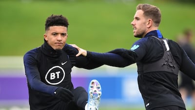 England midfielders Jadon Sancho, left, and Jordan Henderson. Getty
