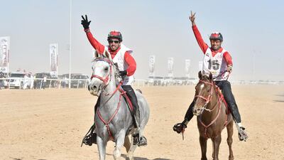 Two riders give the 'three-fingered salute'. WAM