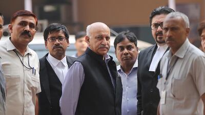 Former junior foreign minister MJ Akbar with his lawyers outside Patiala House court in New Delhi, India. Rajat Gupta / EPA