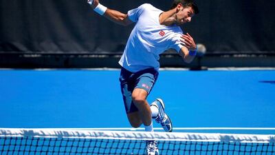 Novak Djokovic reacts to avoid being hit by a ball during a training session. David Gray / Reuters