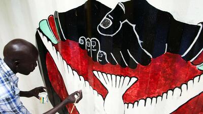 A member of the new activist movement #AnaTaban, paints a new mural at the Aggrey Jaden cultural centre in Juba, South Sudan, on September 18, 2016. #AnaTaban was founded recently by 40 young South Sudanese artists who are calling for an end to civil conflict through the arts. Albert Gonzalez Farran / AFP