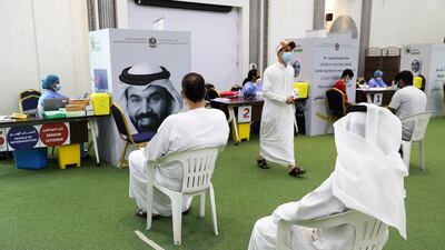 People waiting for their turn to get the Covid-19 vaccine at the Ajman Society of Social and Cultural Development. All photos: Pawan Singh / The National