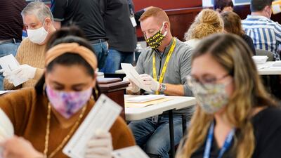 Municipal workers extract Luzerne County ballots from their envelopes, in Wilkes-Barre, Pa. The fate of the United States presidency hung in the balance Wednesday morning, as President Donald Trump and Democratic challenger Joe Biden battled for three familiar battleground states, Wisconsin, Michigan and Pennsylvania, that could prove crucial in determining who wins the White House. AP Photo