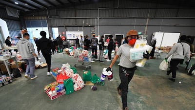 Volunteers scramble to organise food and personal hygiene supplies at the Australian Muslim Social Services Agency in Melbourne, Australia. EPA