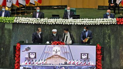 Iran's newly elected President Ebrahim Raisi takes the oath at the podium in the Iranian parliament in the capital Tehran.