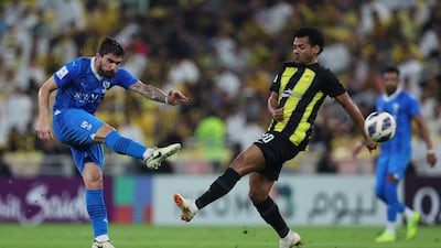 Al Hilal's Ruben Neves takes as Romarinho of Al Ittihad tries to close him down. Getty Images